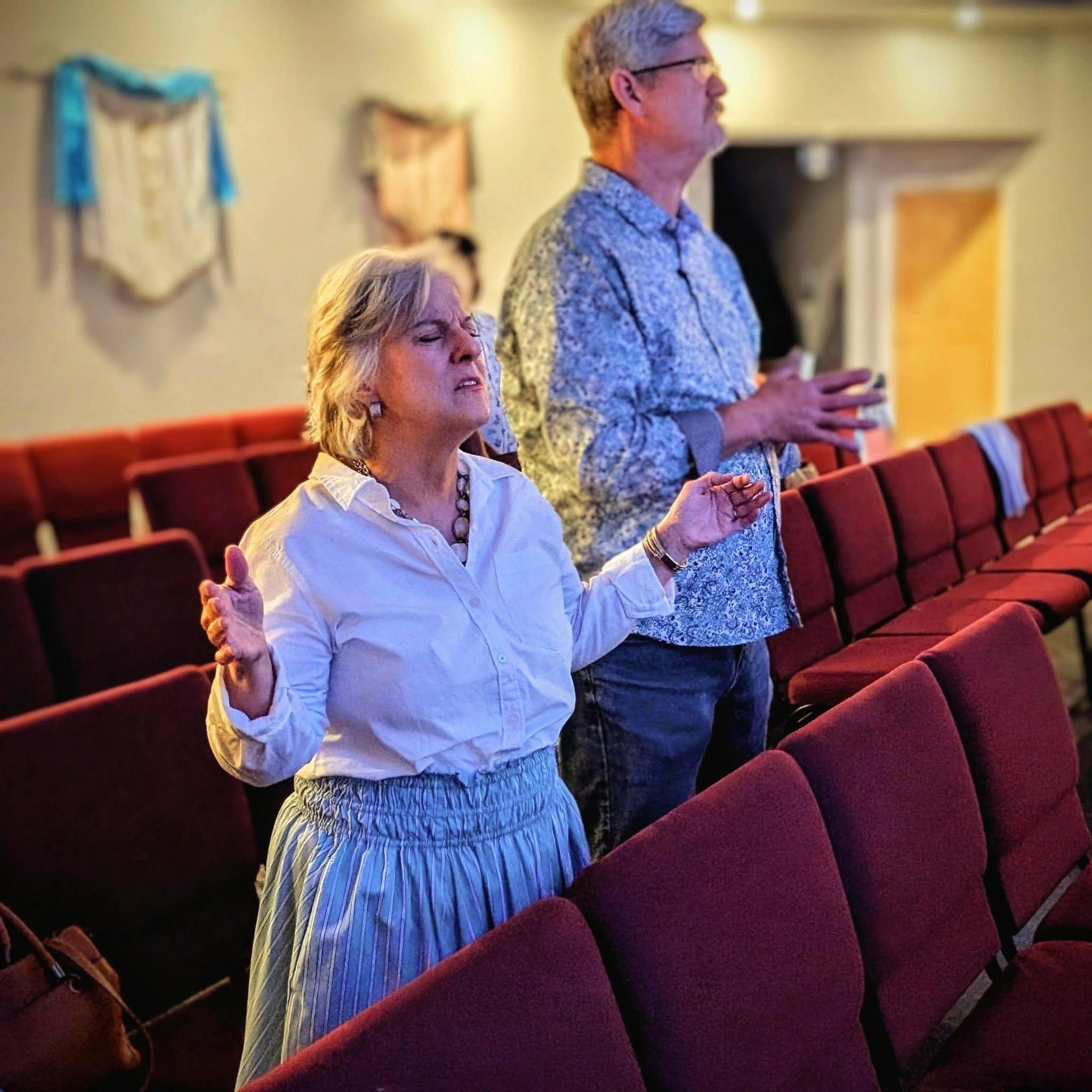 Two in the sanctuary — red seats